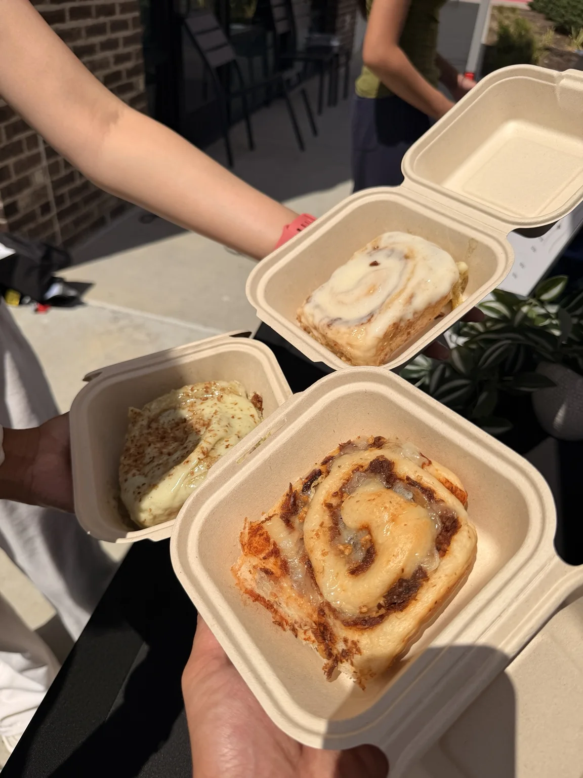 Assorted NOTO cinnamon rolls in takeaway boxes